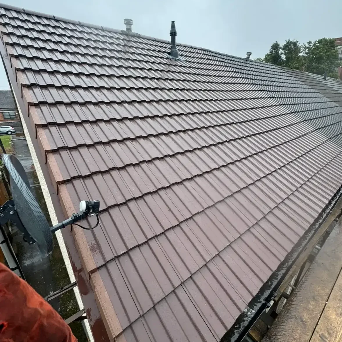 Completed pitched roof with brown tiles installed by LJM Roofing.